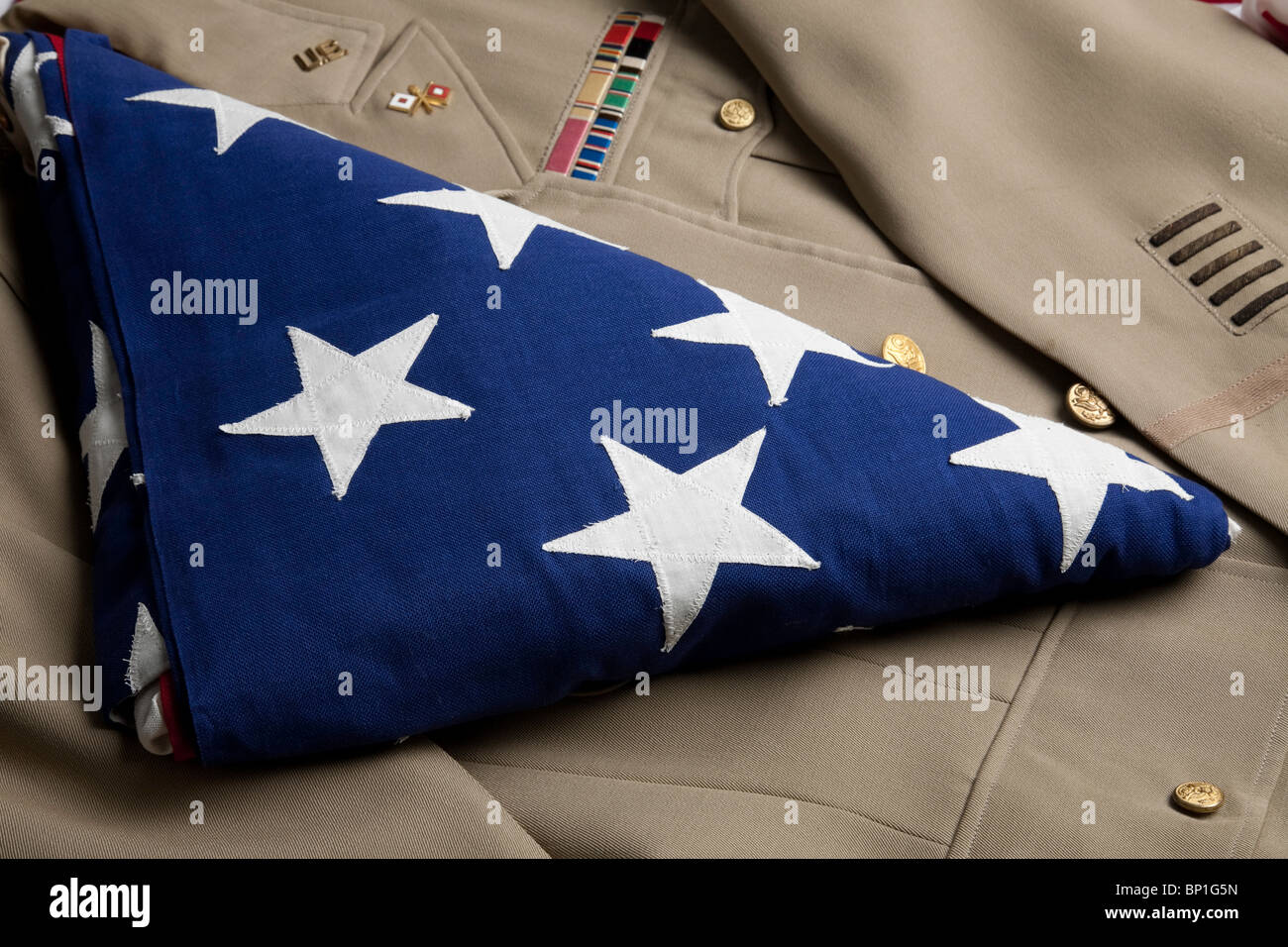 Veteran's Folded Flag on His WW2 Uniform Stock Photo