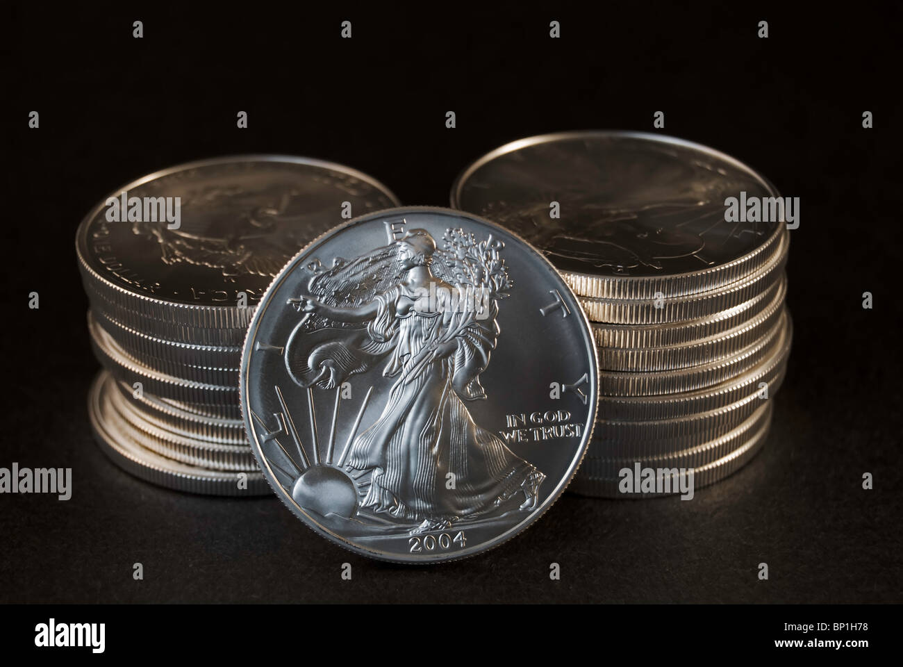 Stacks of U.S. Silver Eagle coins with view of Lady Liberty showing on
