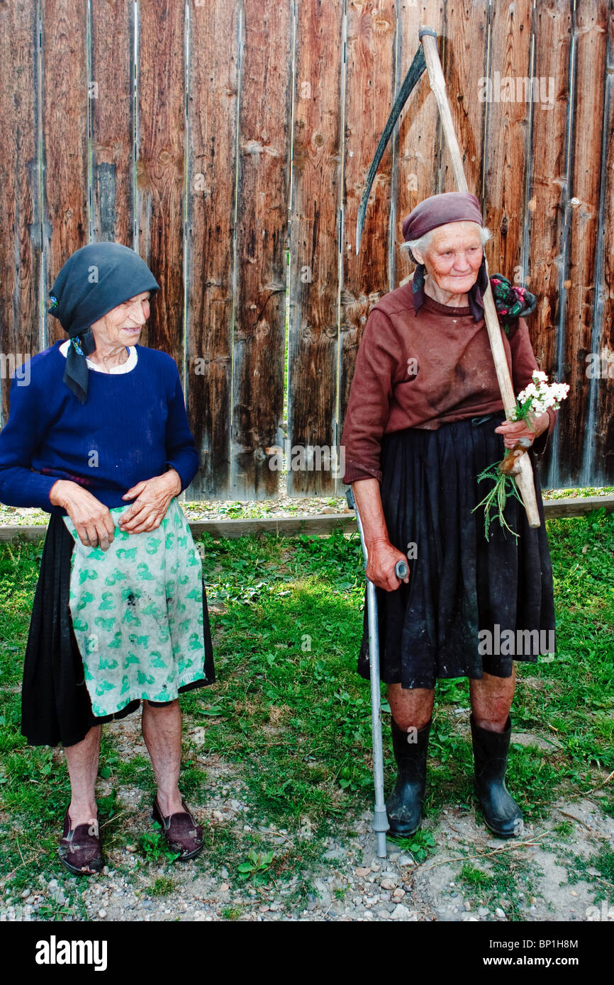 Two old women from Maramures, Romania, coming back from the field's work at the end of the day Stock Photo