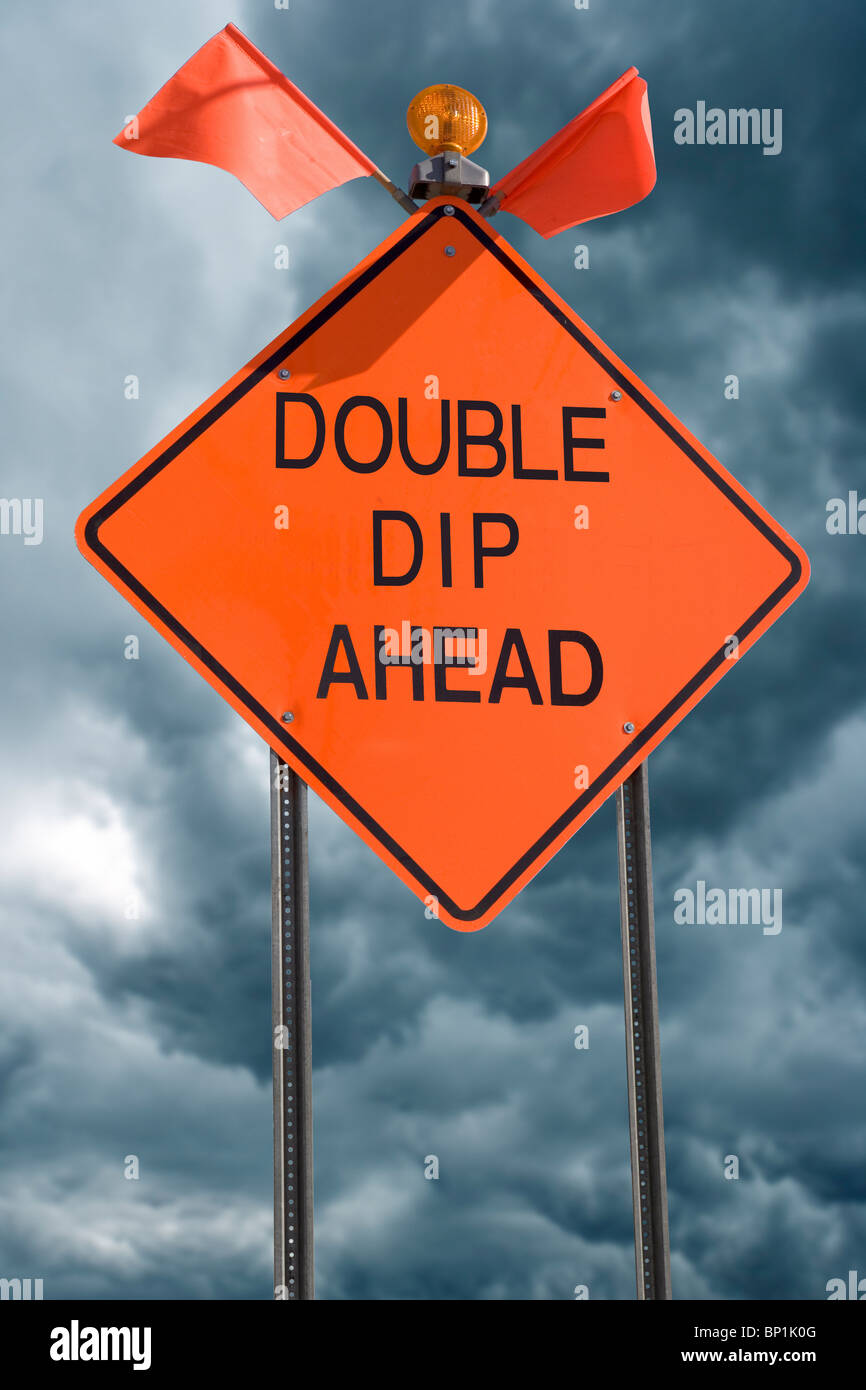 An orange highway safety sign with the words 'Double Dip Ahead' on it referring to the possibility of a Double Dip Recession Stock Photo