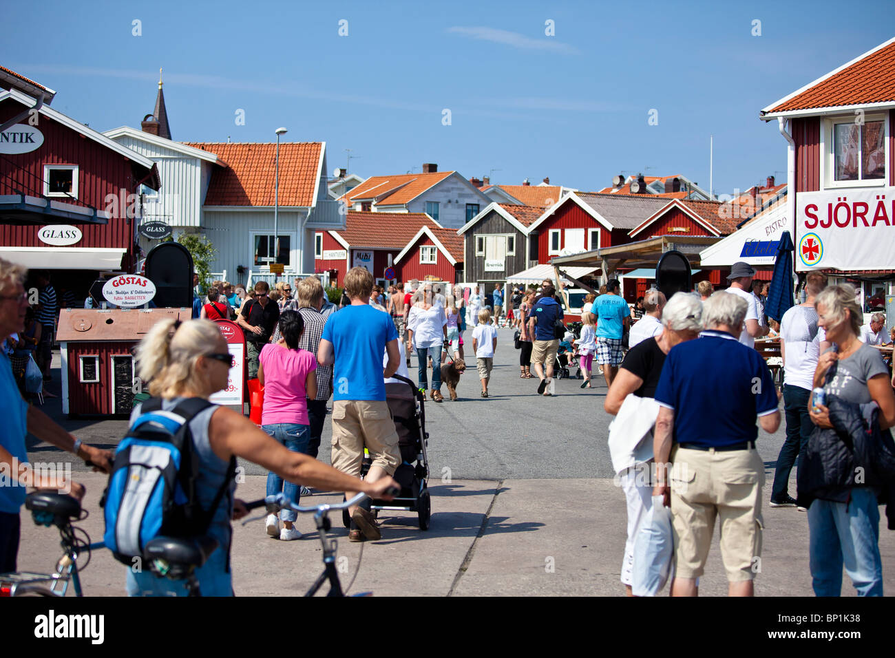 People walking on a street in the summer. Smogen Brygga, Sweden Stock Photo