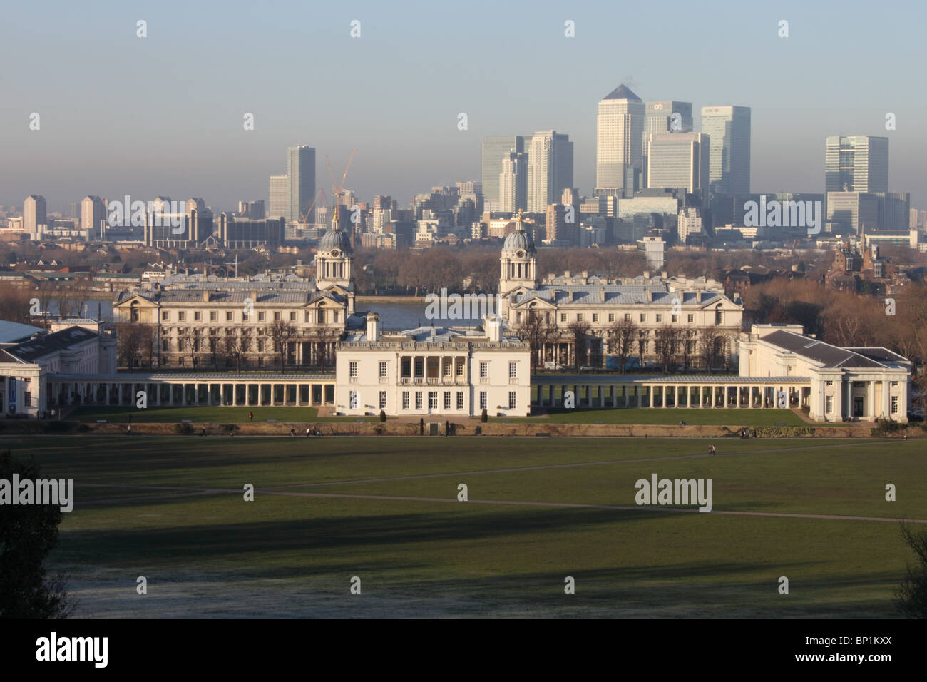 View across Greenwich Park to The Queens House and Royal Naval College, with River Thames and Canary Wharf in background, London Stock Photo