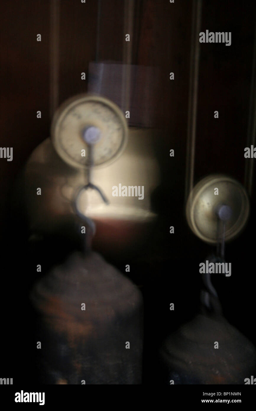 a spooky image of a pendulum inside an antique grandfather clock