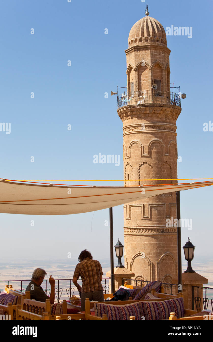 Tourists at a cafe overlooking Ulu Cami, Mardin, Turkey Stock Photo