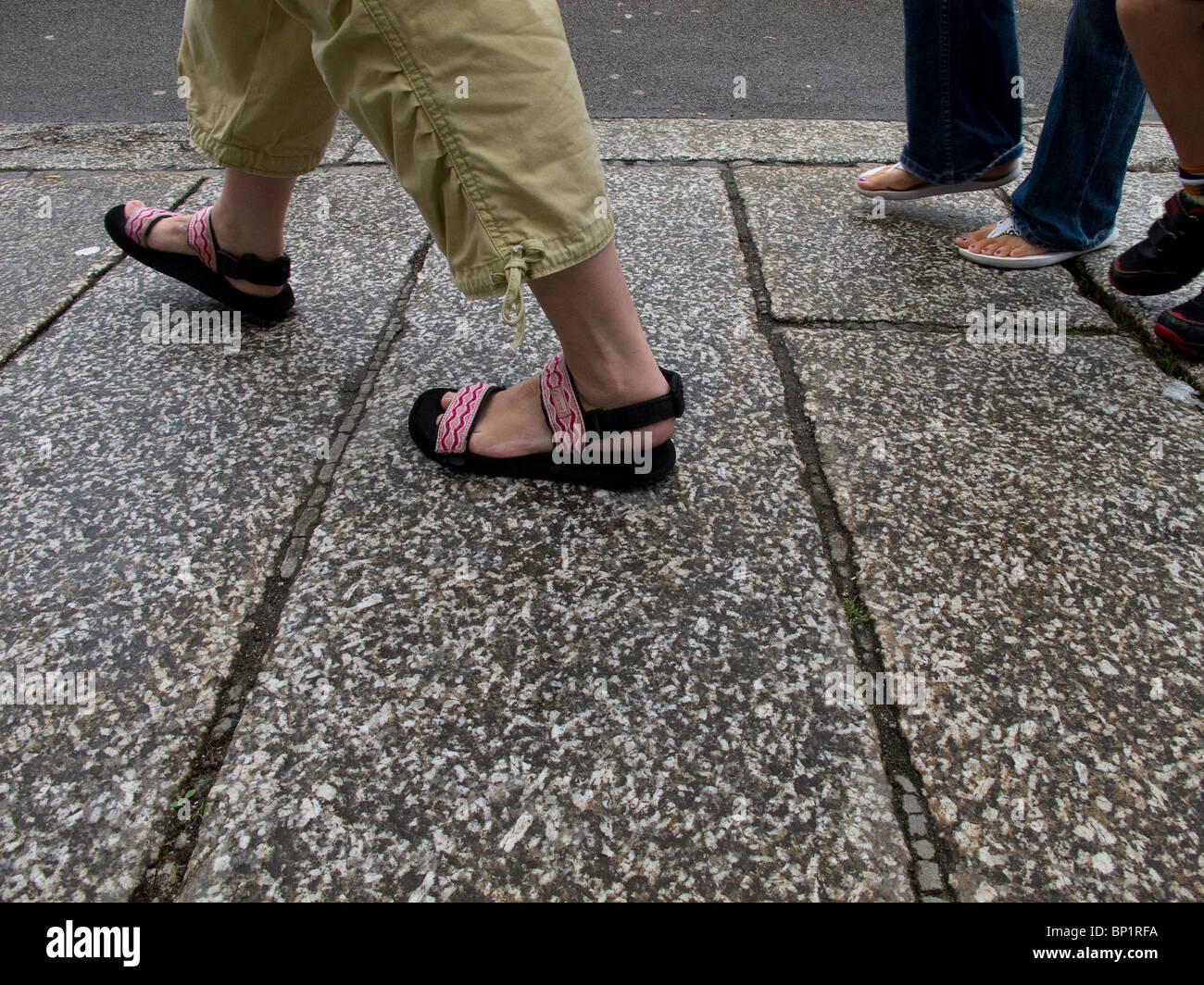 People walking on a pavement. Stock Photo