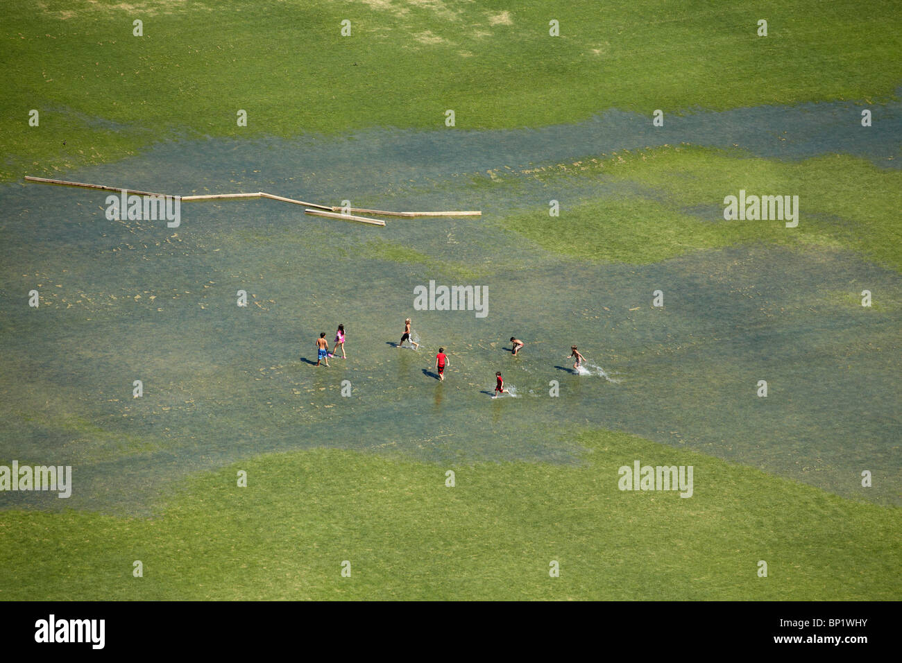 Children Playing on Flooded Sports Field, Vitacura, Santiago, Chile, South America - aerial Stock Photo