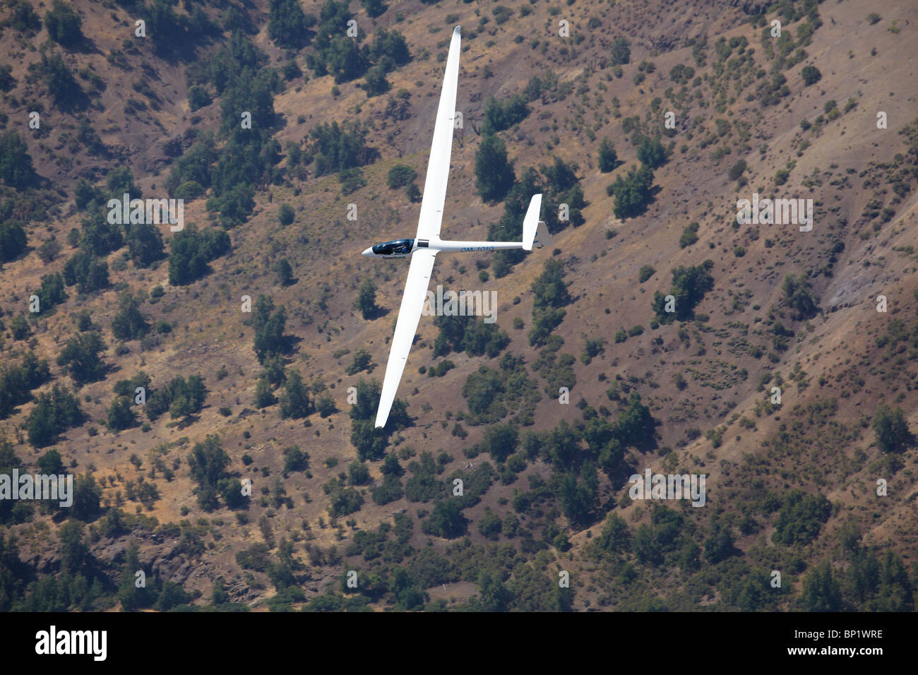 Glider Pilot Sarah Kelman over Andes Foothills, near Santiago, Chile, South America - aerial Stock Photo