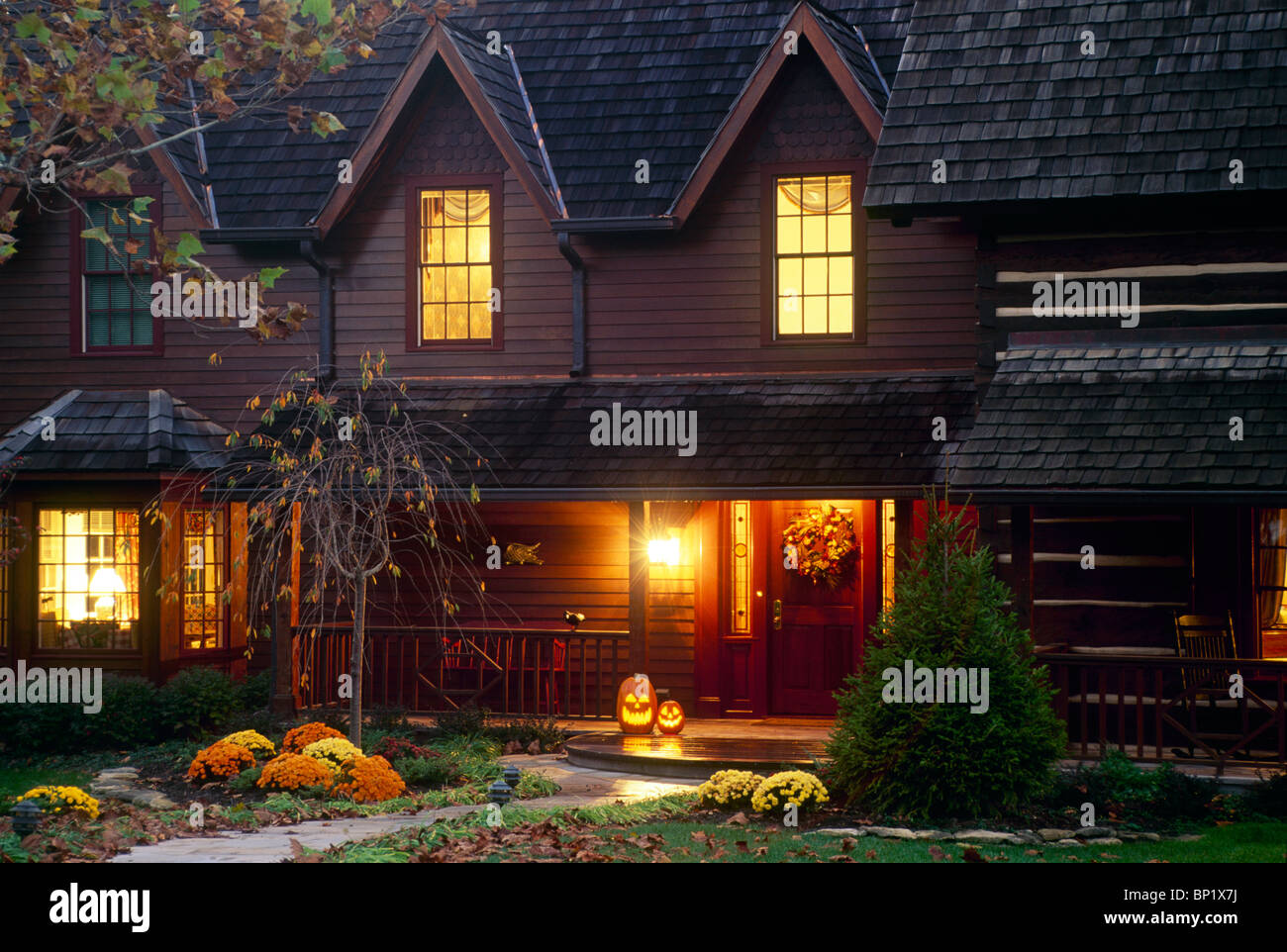 Renovated cabin into new home lit for Halloween and welcoming neighbors, Midwest USA Stock Photo