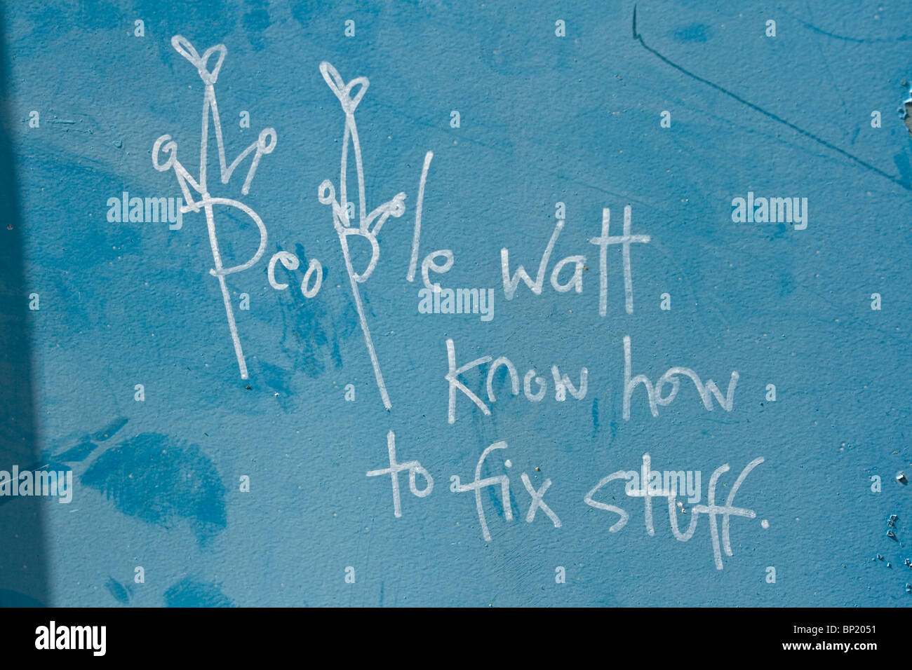 Graffiti on a blue wall suggesting what is needed in the world. Stock Photo