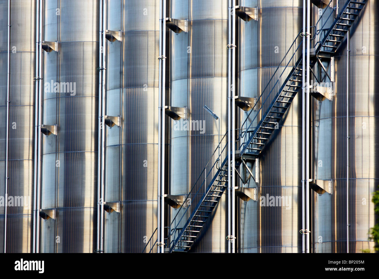 Big stainless steel tanks for chemicals in a chemical factory. Outside staircase. Stock Photo
