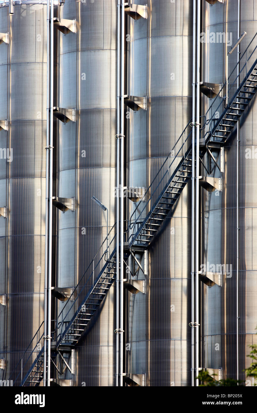 Big stainless steel tanks for chemicals in a chemical factory. Outside staircase. Stock Photo