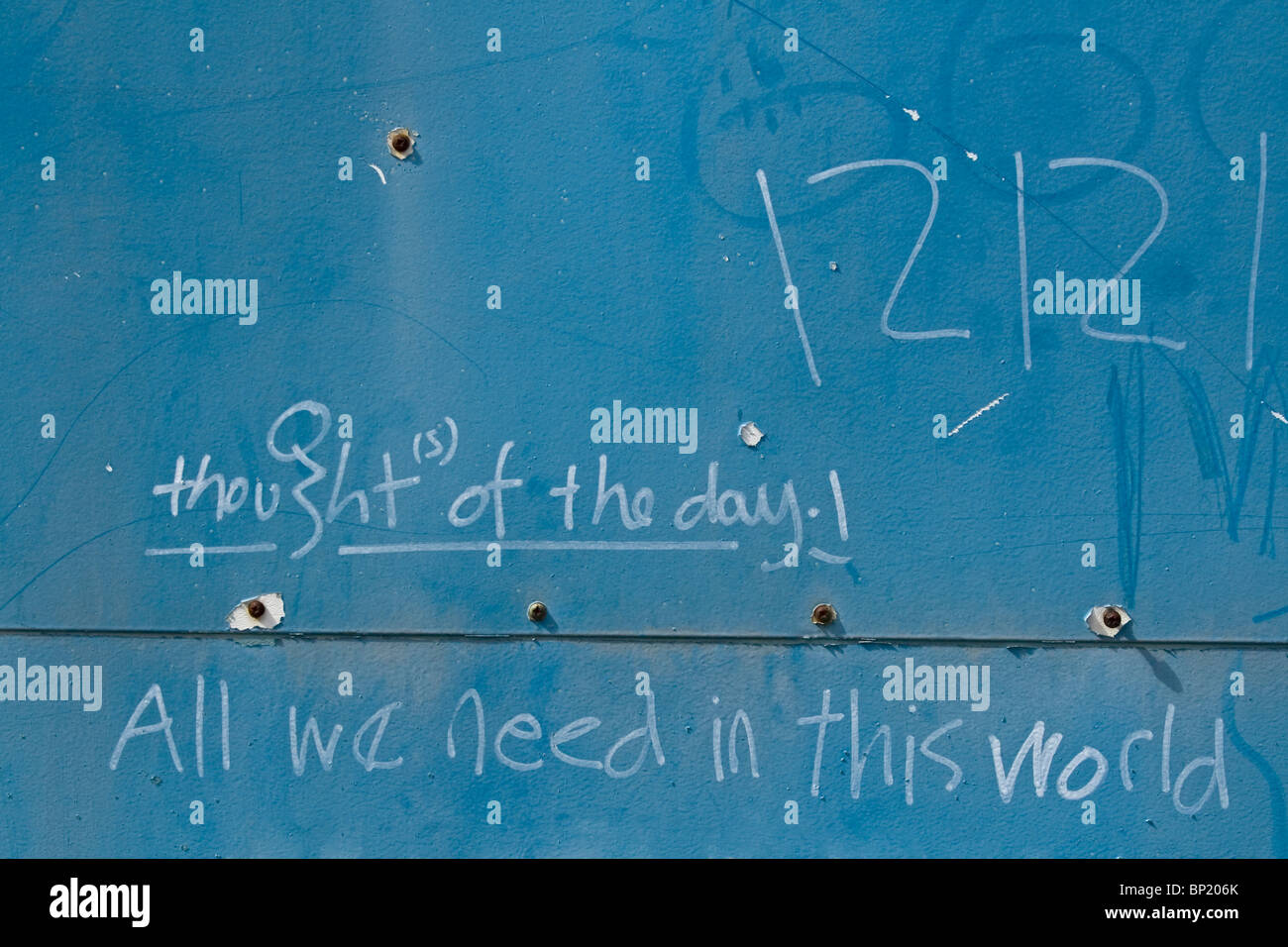 Graffiti on a blue wall suggesting thought of the day. Stock Photo