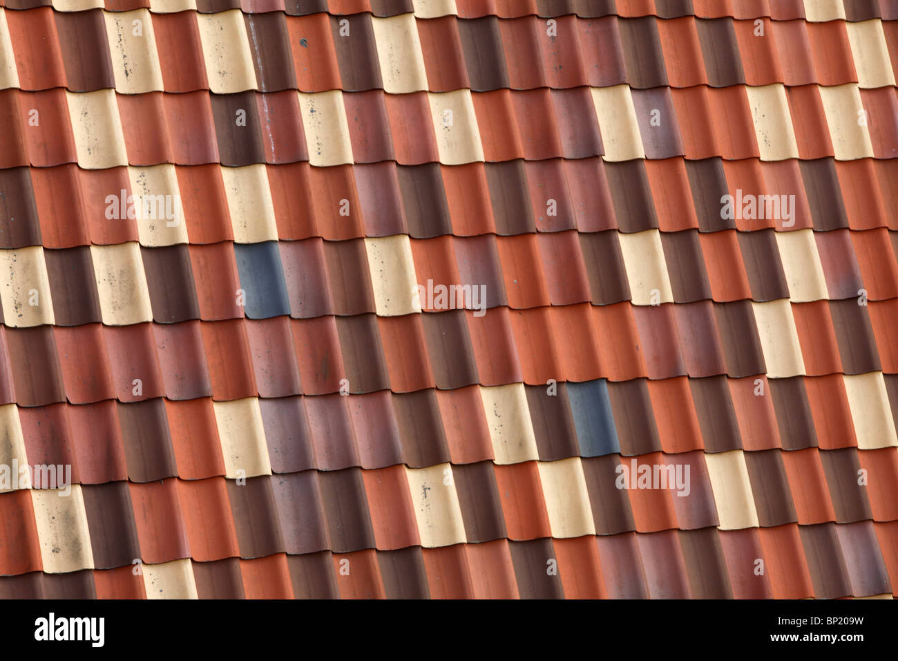 Colorful roof tiles, on the roof of an old building, made of clay. Stock Photo