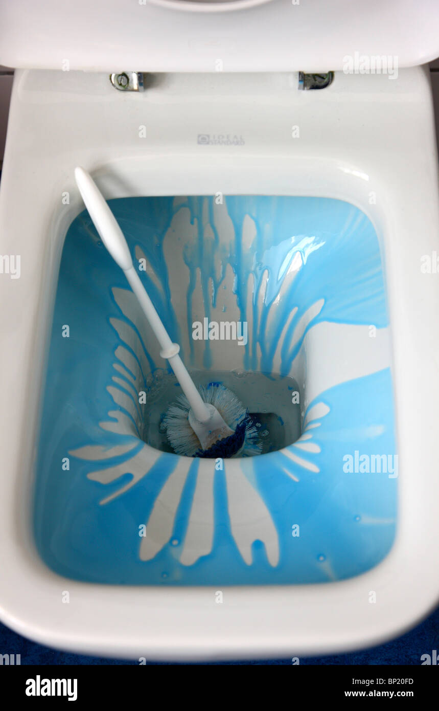 Blue cleaning agent in a toilet bowl, for household hygiene. Stock Photo