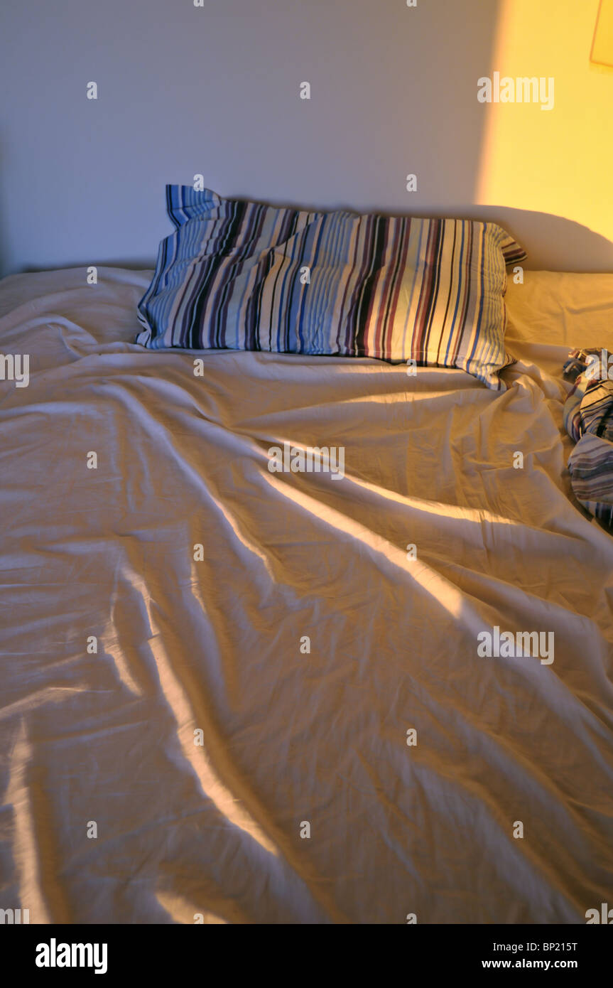 Unmade messy bed with wrinkled sheets from above Stock Photo Alamy