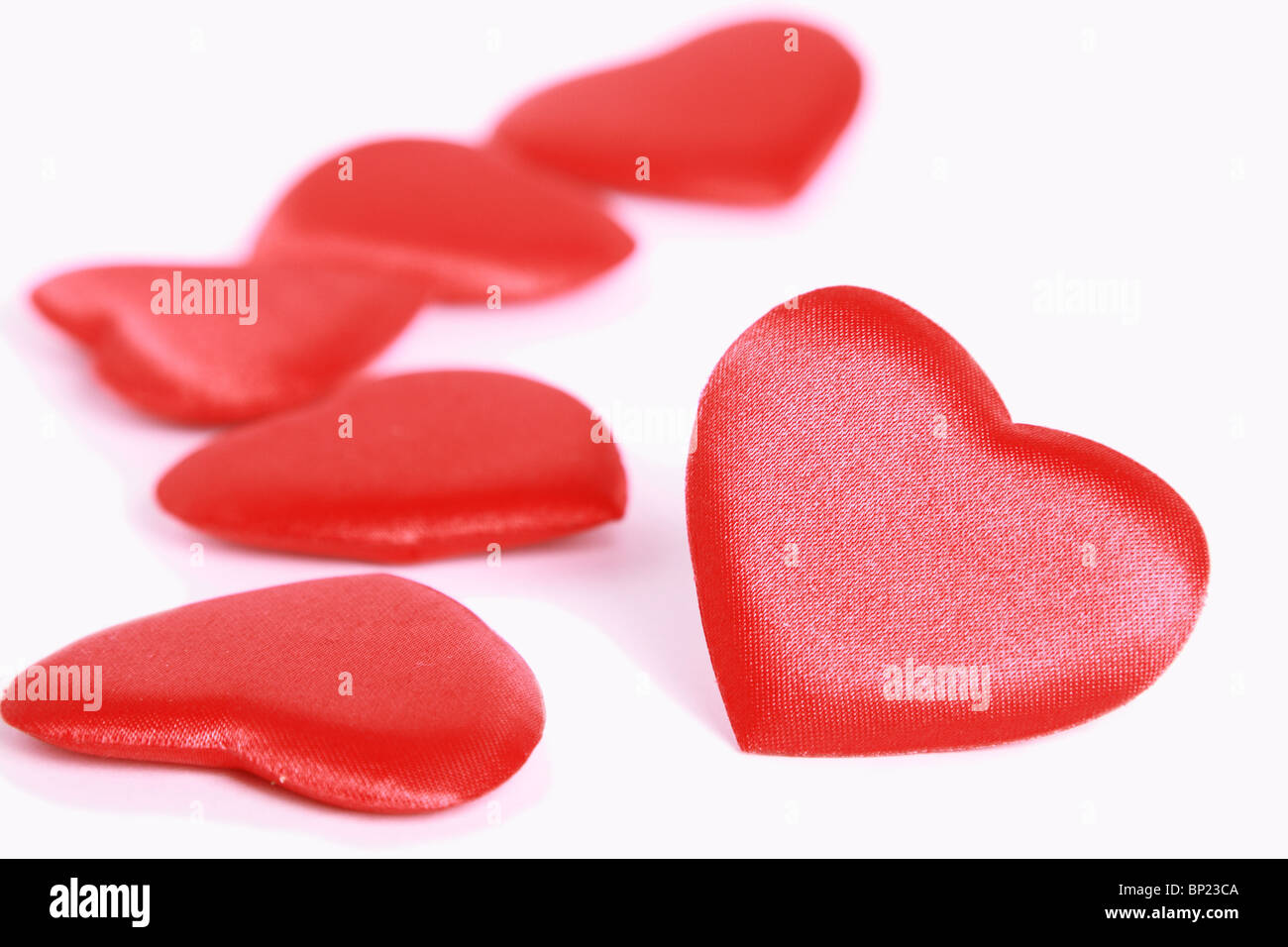 Red shiny hearts on white Stock Photo - Alamy