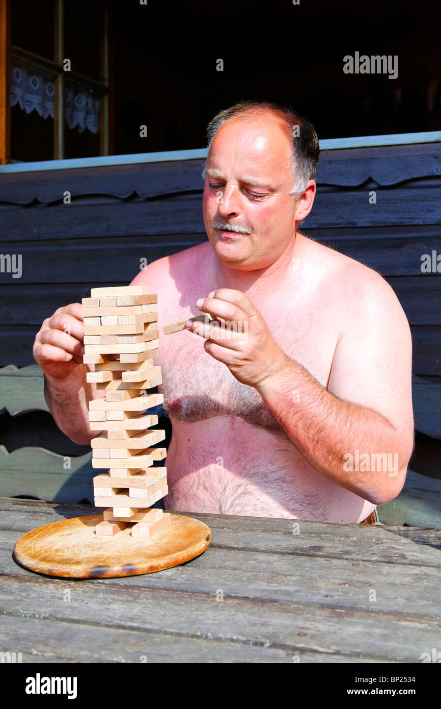 Mature Man playing a tricky board game Stock Photo Alamy