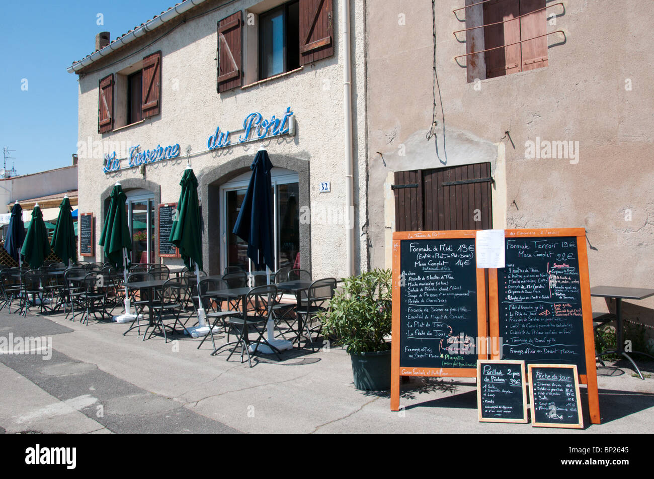 La Taverne du Port restaurant on the harbour front at Marseillan,  Languedoc, France Stock Photo - Alamy
