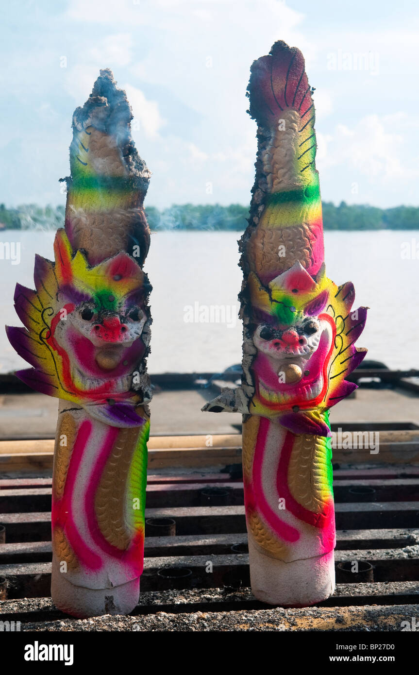 Giant incense sticks with dragon faces burning at Tua Pek Kong Temple. Stock Photo