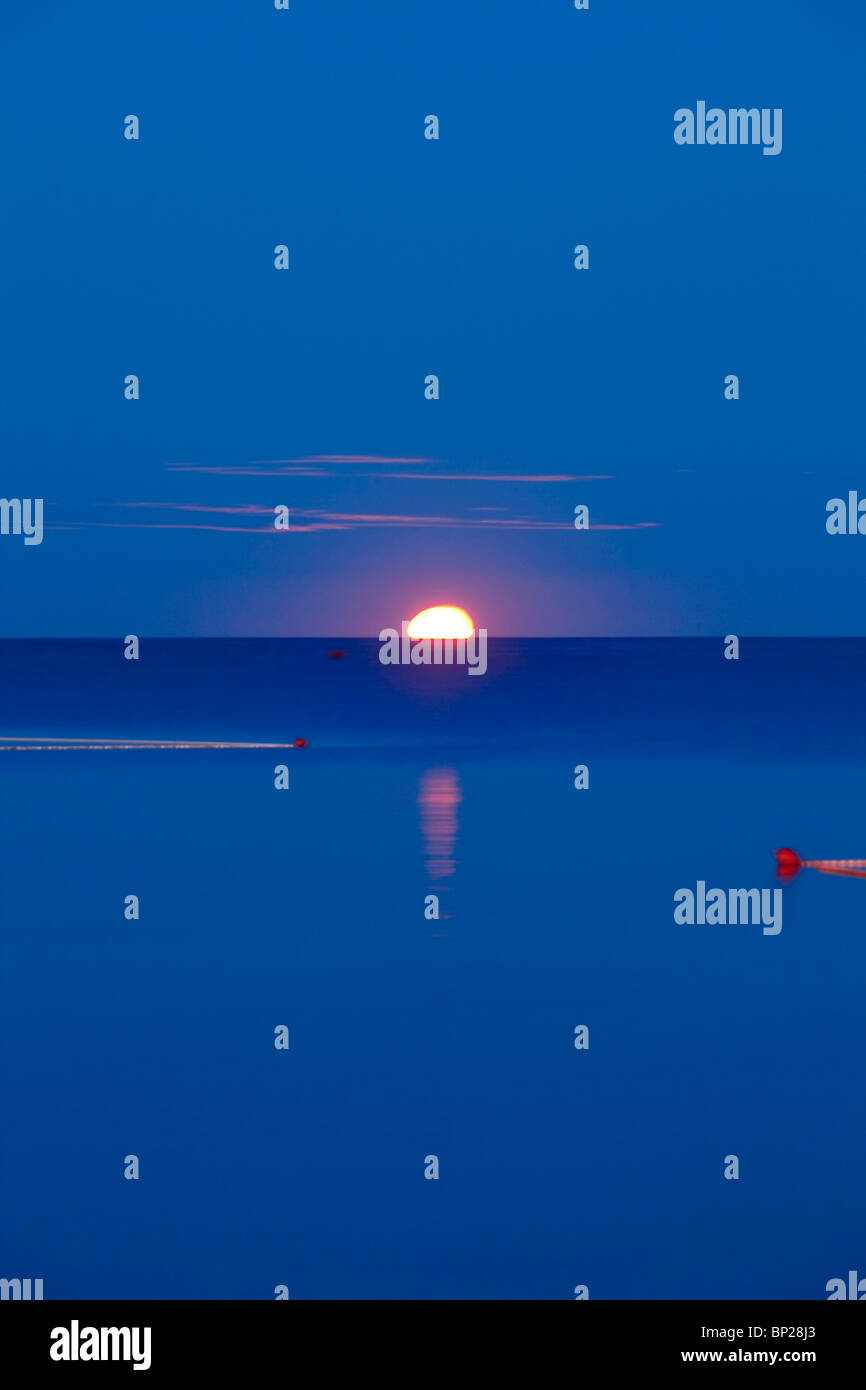 croatia, istria - full moon setting over adriatic sea at dawn Stock Photo