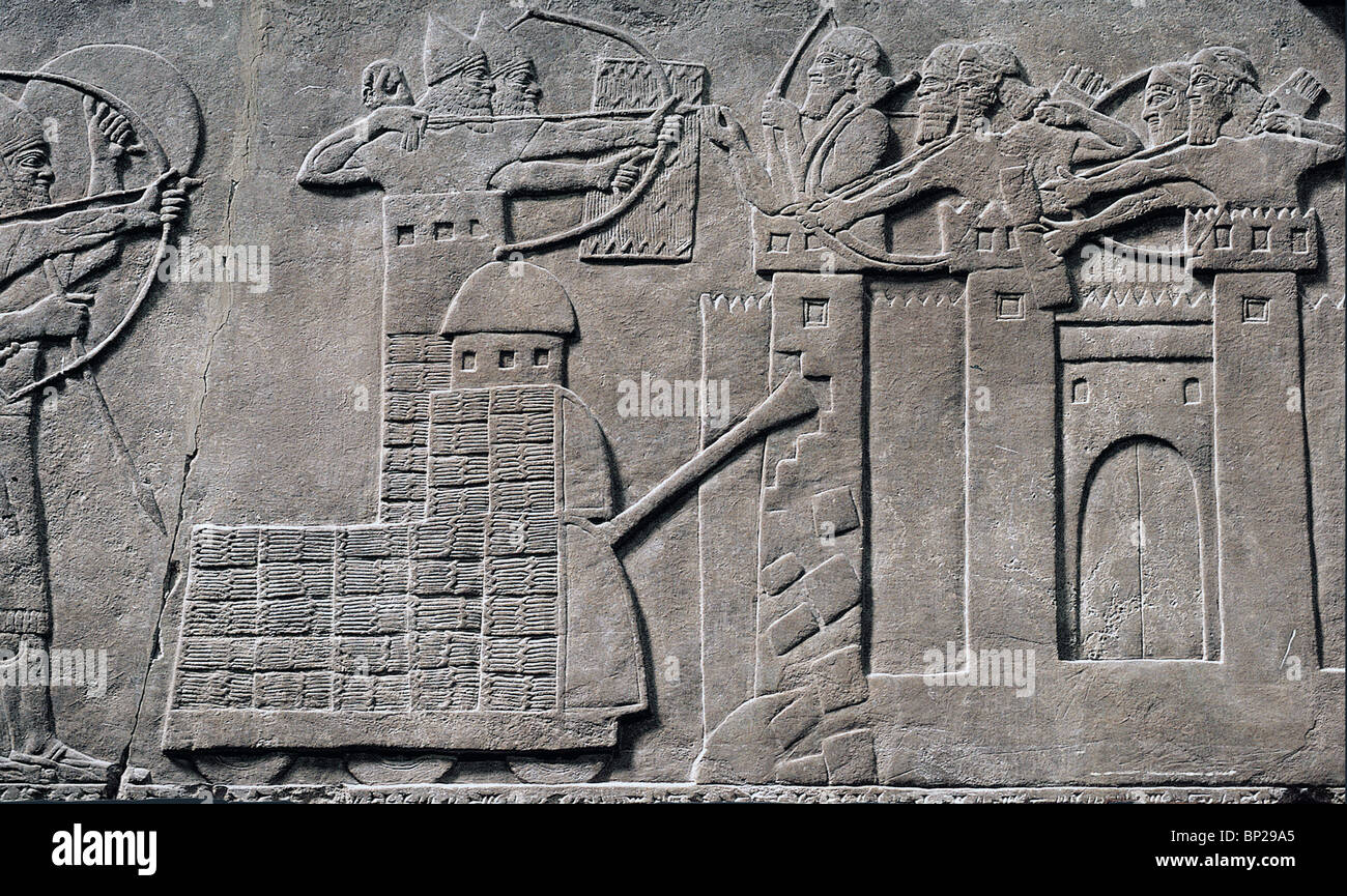 SIEGE TOWER & BATTERING RAM IN ACTION ASSYRIAN ARMY DESTROYING THE WALLS & TOWERS OF A FORTIFIED CITY. RELIEF FROM NIMRUD C. Stock Photo