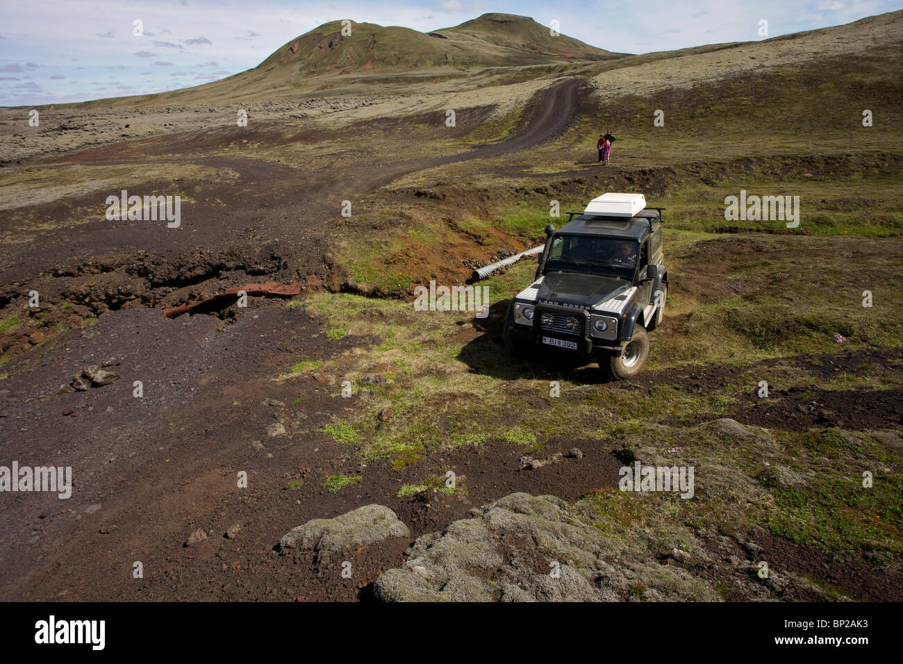 Land Rover Defender 90 300TDI navigates a washed out road in the highlands of Iceland Stock Photo
