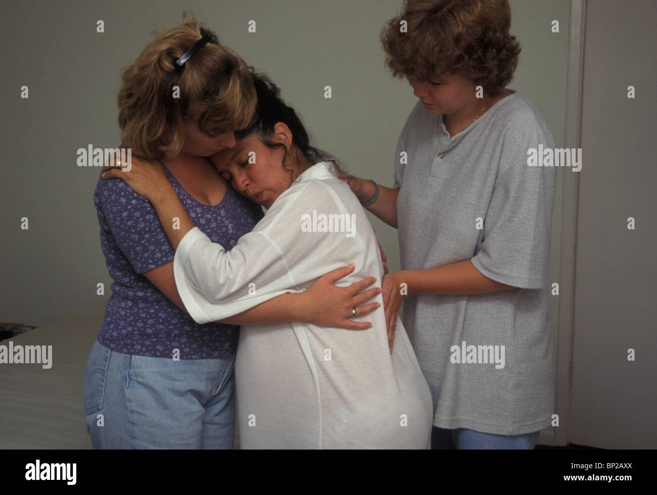 woman in labour being supported by her friends Stock Photo
