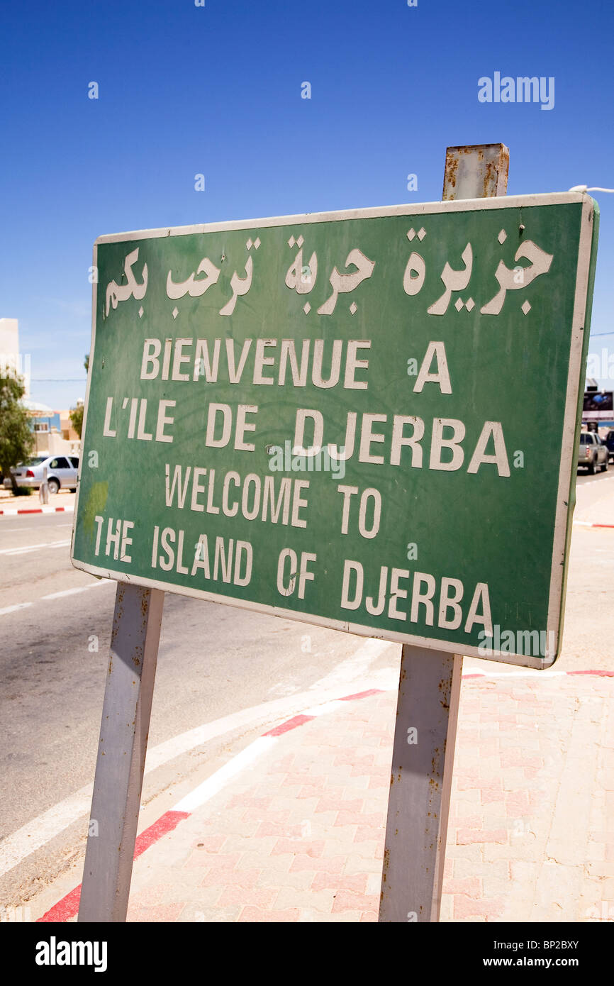A sign in Arabic, French and English welcomes people to the island of Djerba in Tunisia. Stock Photo