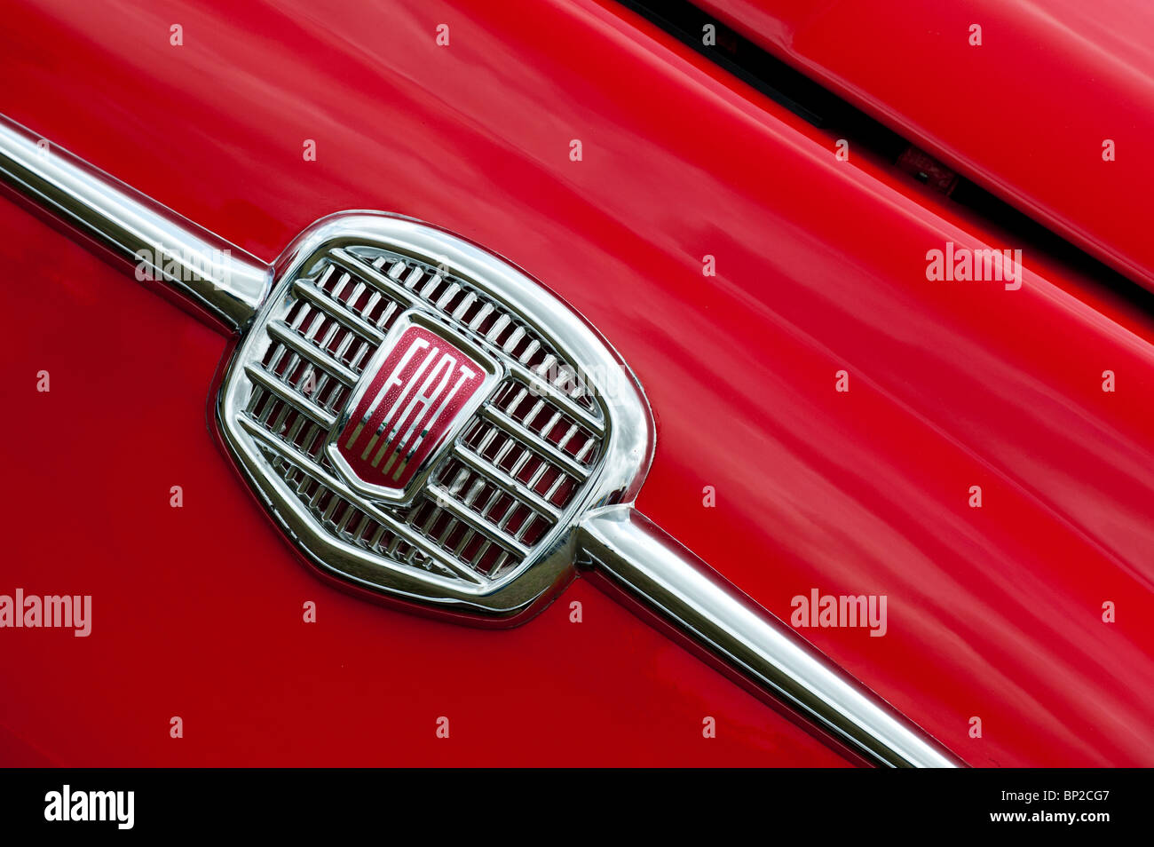 1968 Fiat 500 chrome car badge on a red car close up Stock Photo