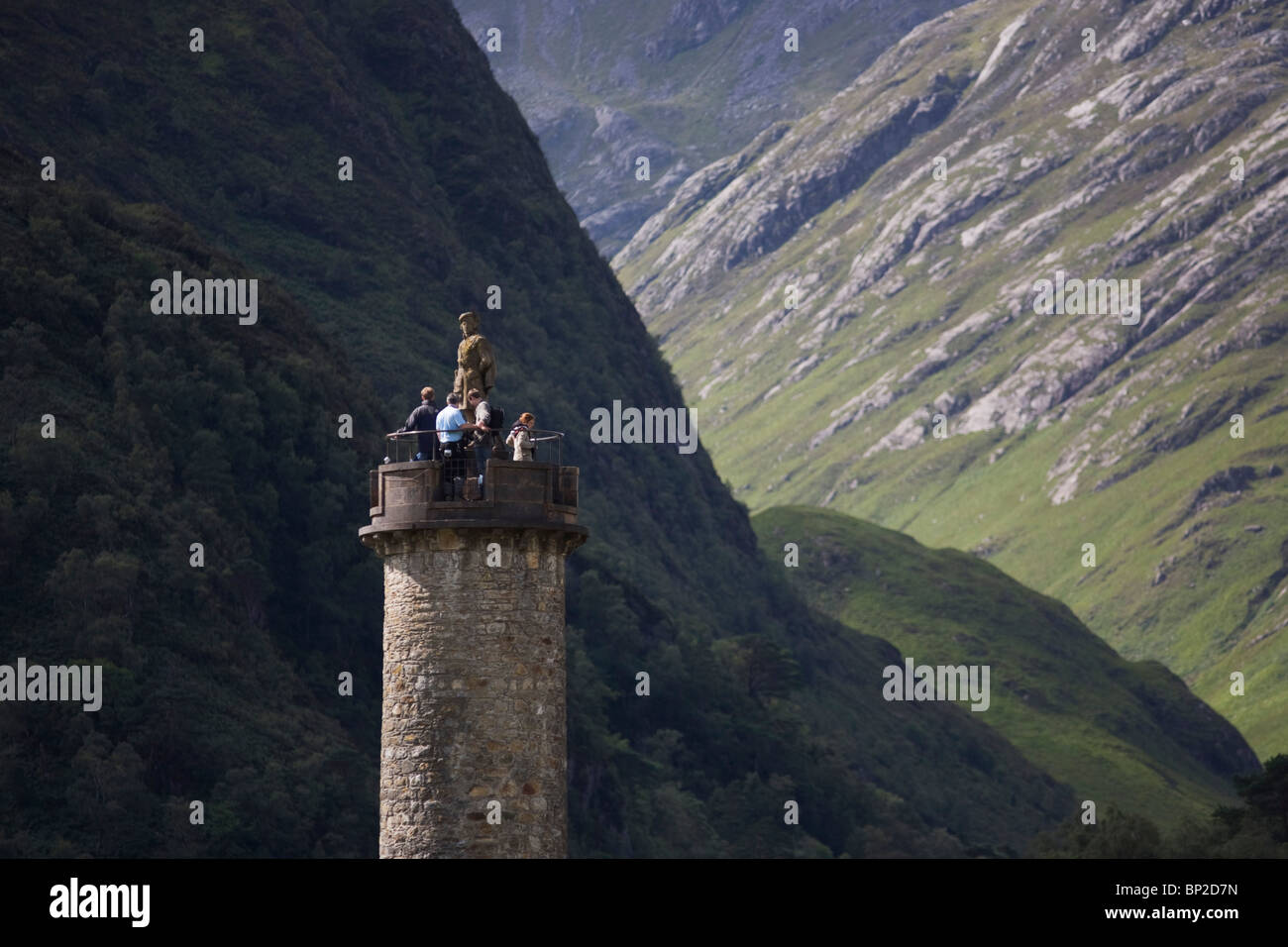 Tourists on Glenfinnan Monument built where Scottish Jacobite Bonnie Prince Charlie first raised