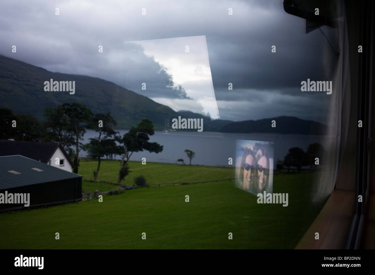 TV holiday women and bleak-looking Scottish Loch in Glencoe area, Scotland. Stock Photo