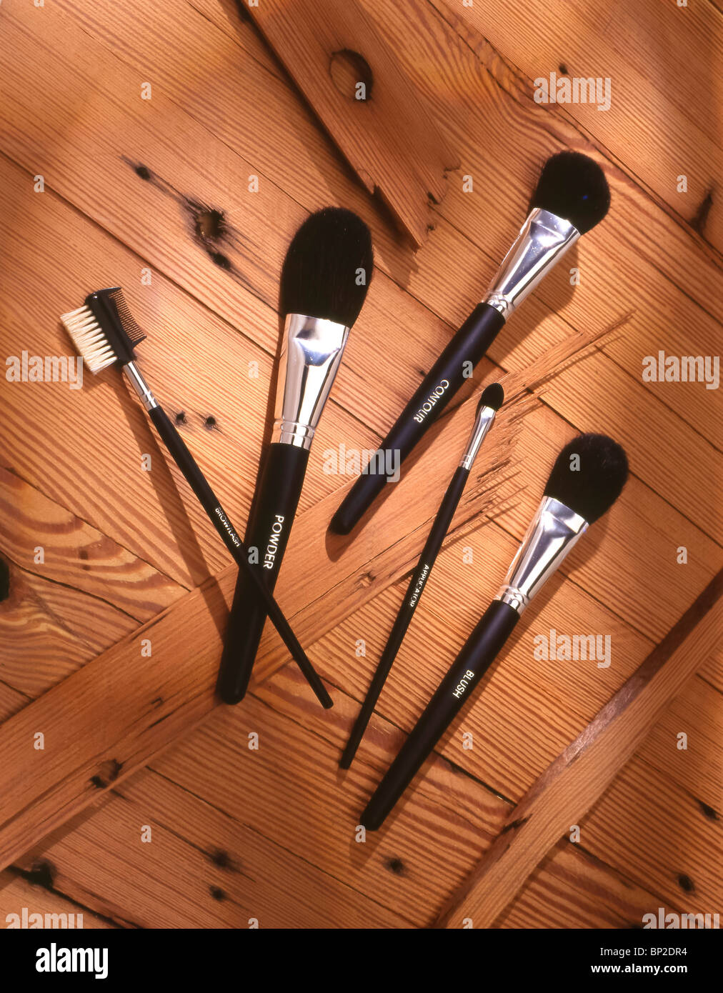 Makeup brushes styled on wood Stock Photo