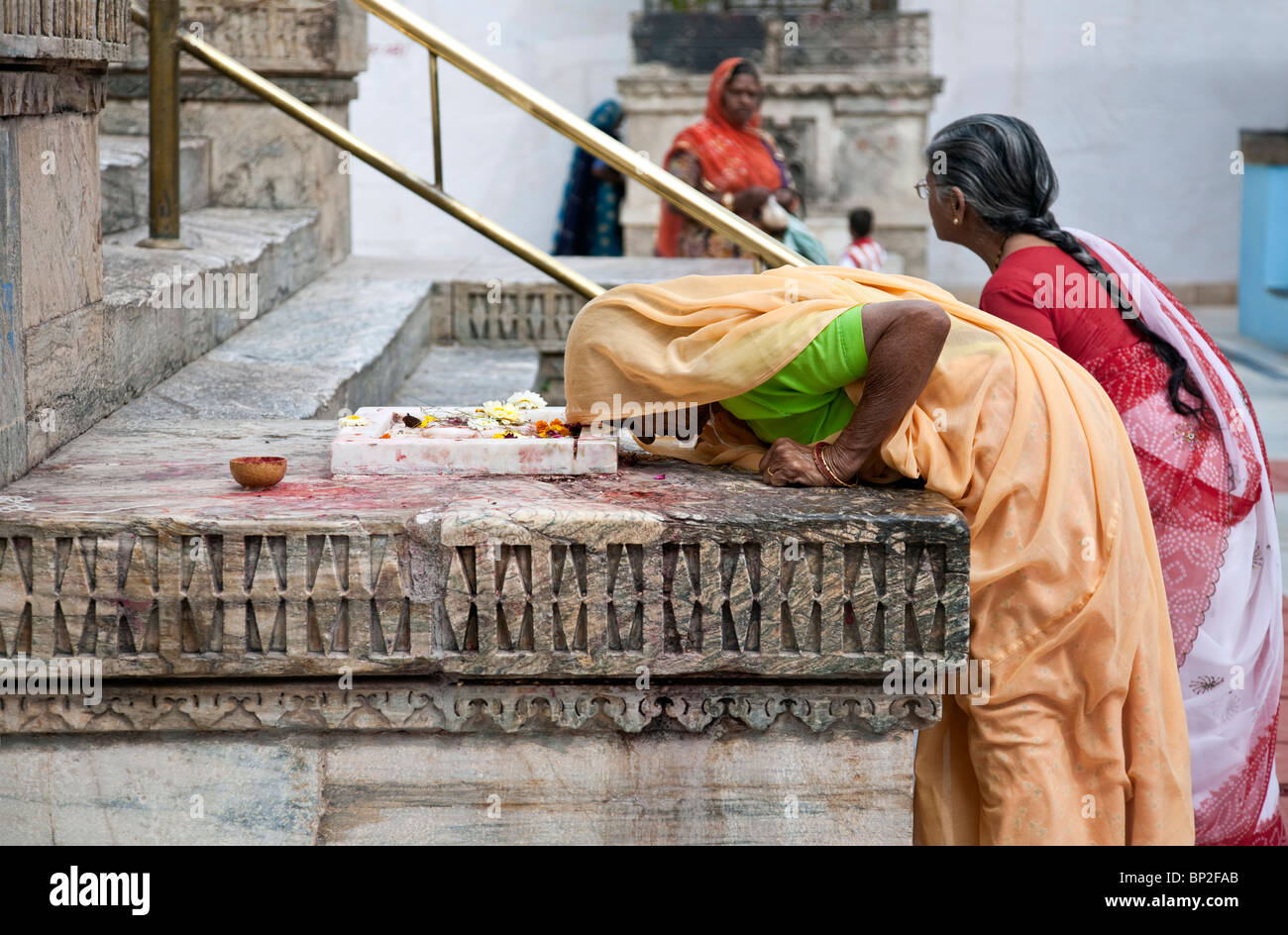 Woman worshiping a sacred altar. Shree Jagdish Temple. Udaipur. Rajasthan. India Stock Photo