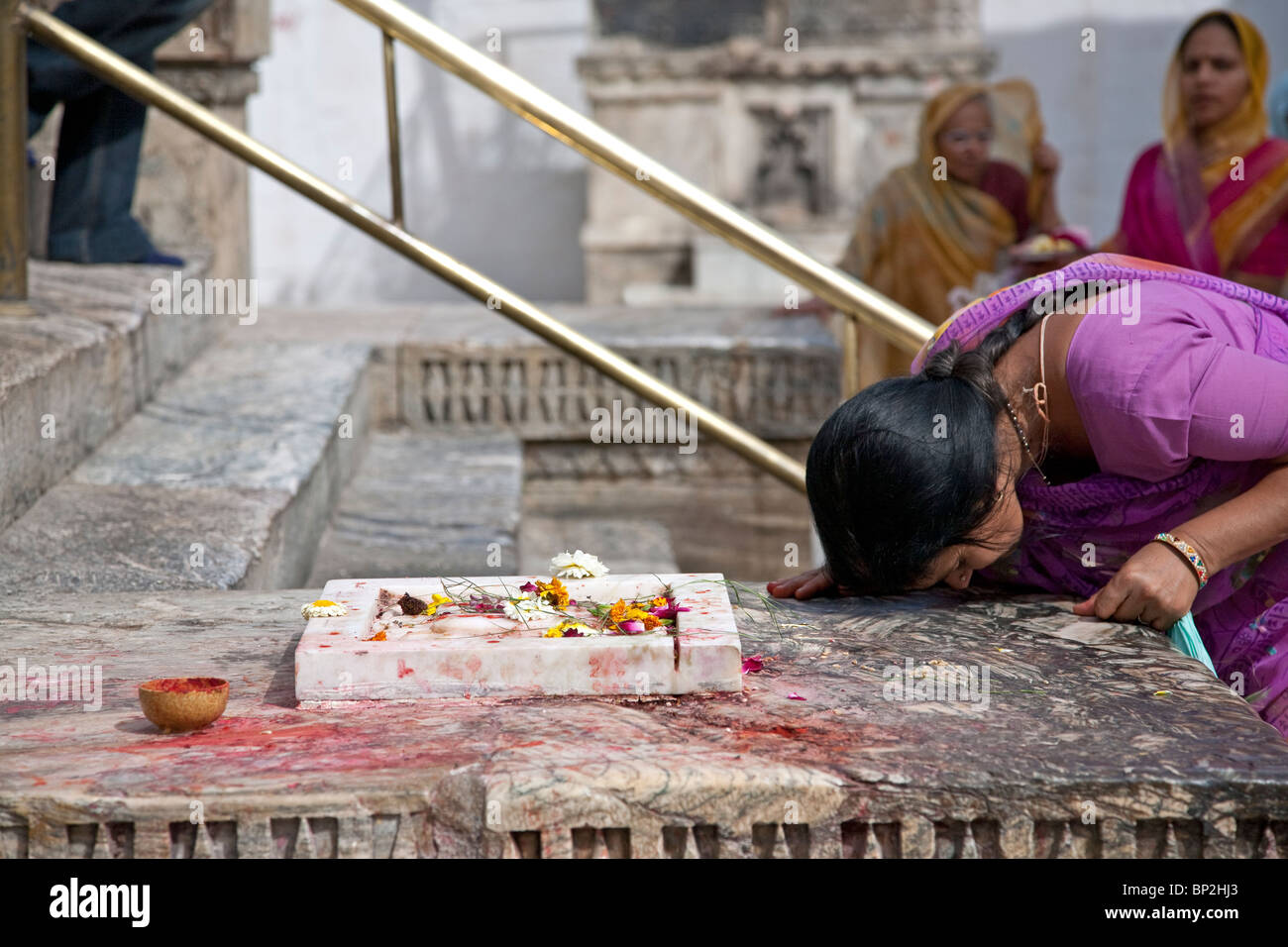 Woman worshiping a sacred altar. Shree Jagdish Temple. Udaipur. Rajasthan. India Stock Photo