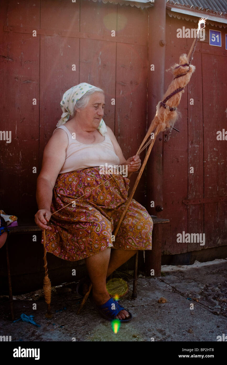 Traditional old woman from Maramures county (Romania), spinning Stock Photo