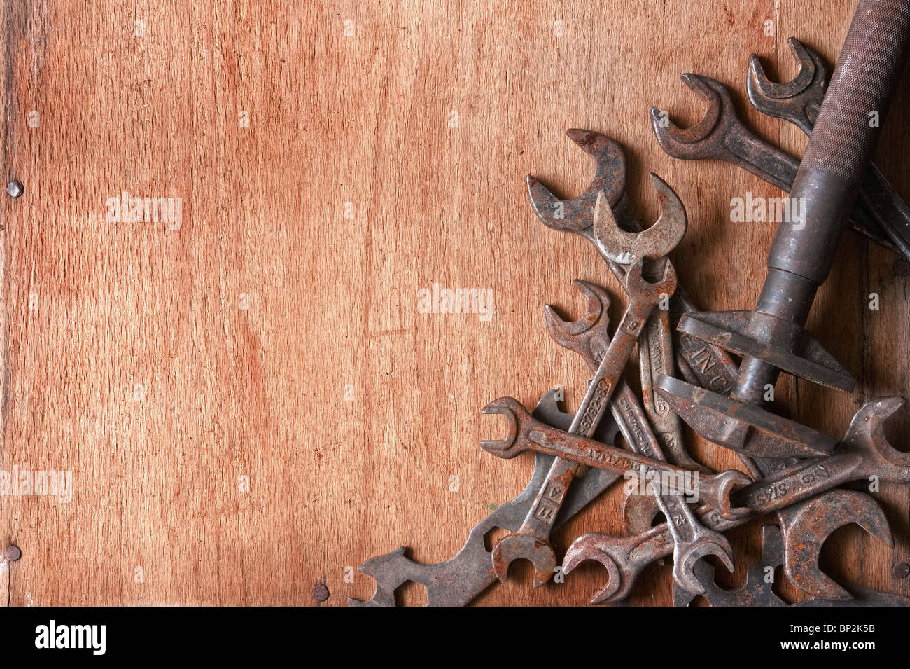 still-life composition of grungy old spaners on wood texture, empty space for text Stock Photo