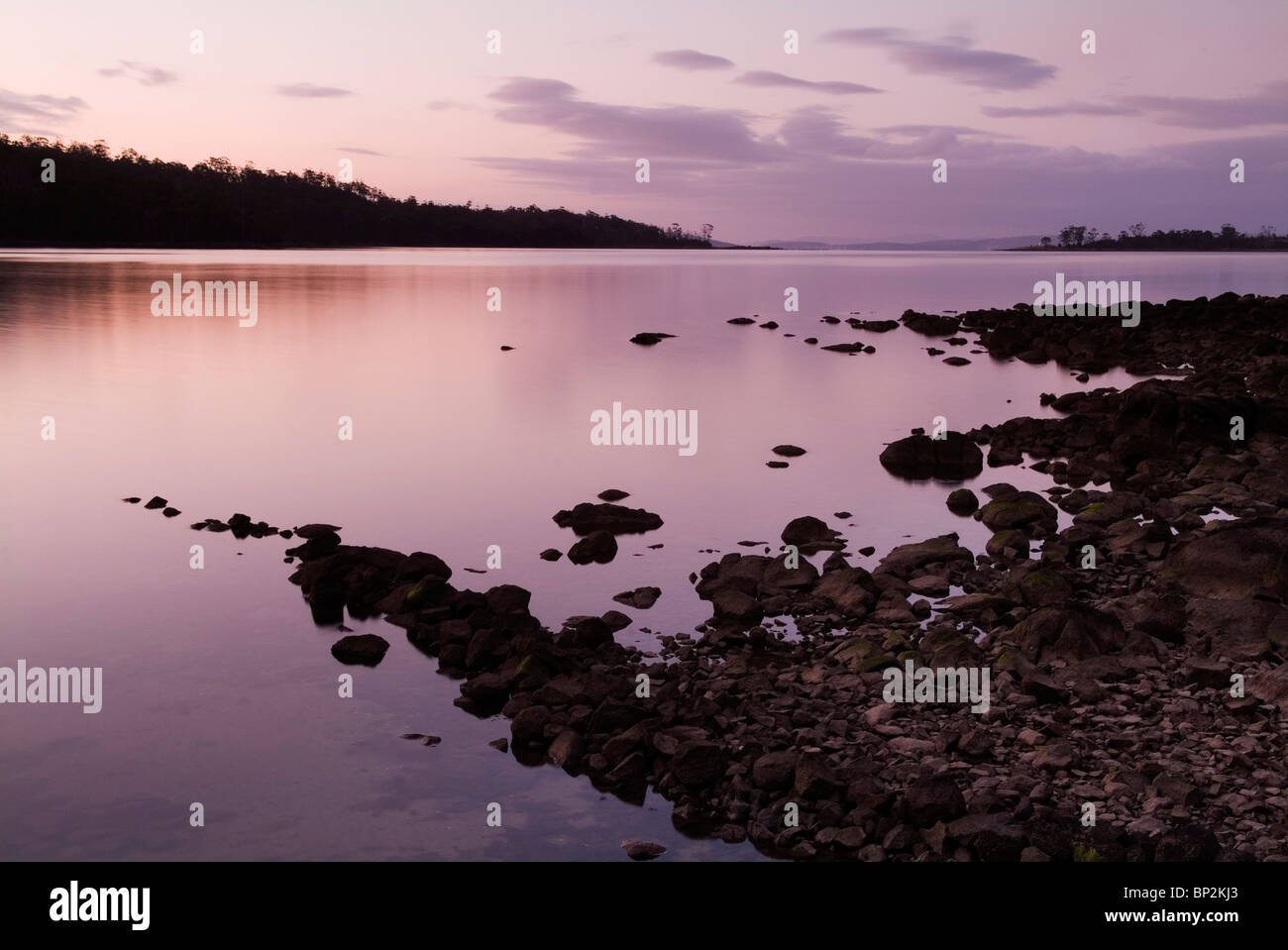 Purple and pink sunset over water Stock Photo - Alamy