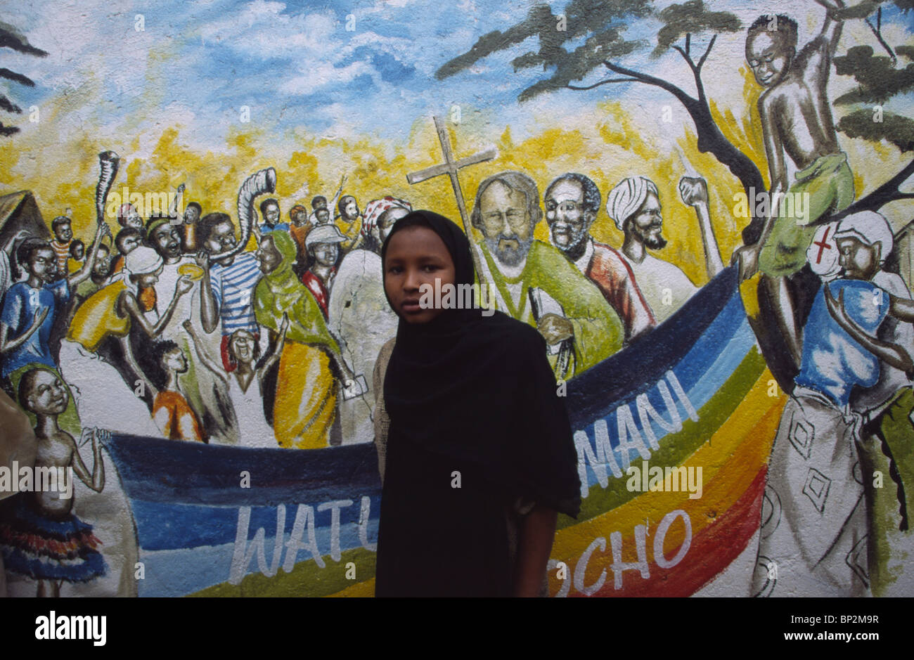 muslim girl in front of street art painting in Korogocho, slum area in Nairobi, Kenya Stock Photo