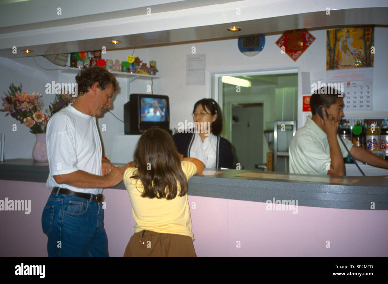 Chinese Take Away Father & Daughter Ordering At Counter Stock Photo