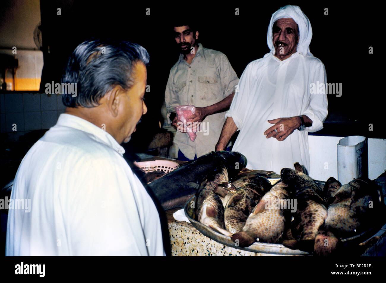 Manama Bahrain Men Talking At Fish Market Stock Photo