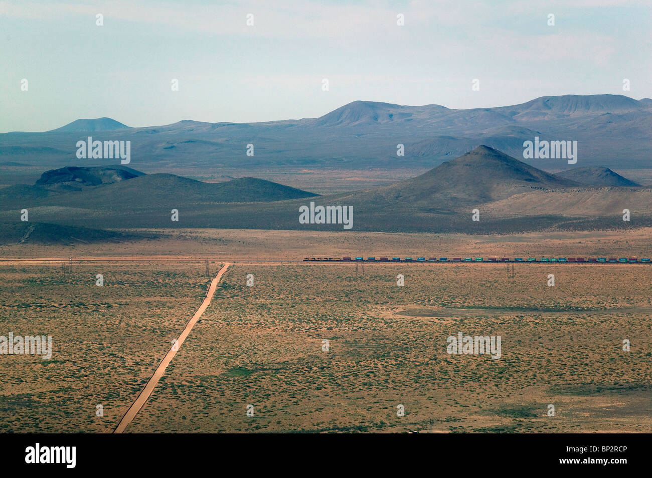 aerial view above freight train passing through New Mexico Stock Photo