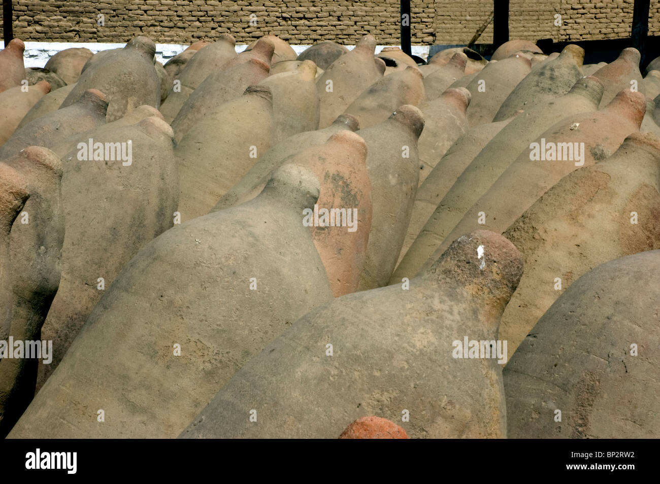 Ancient wine making pisqueras ( earthen ) terracotta jars at a bodega in Ica, Peru. Stock Photo