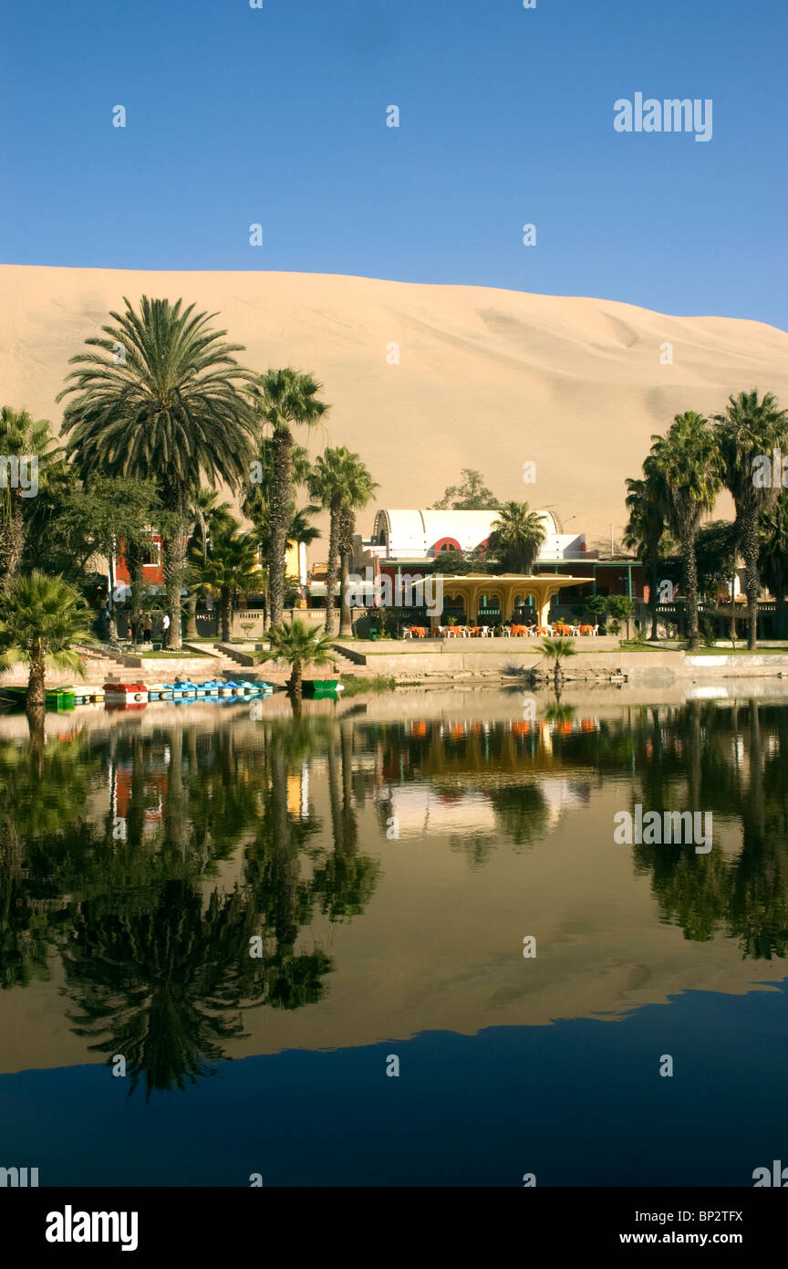 The picturesque lagoon and palm trees of Huacachina Oasis, Ica, Peru. Stock Photo