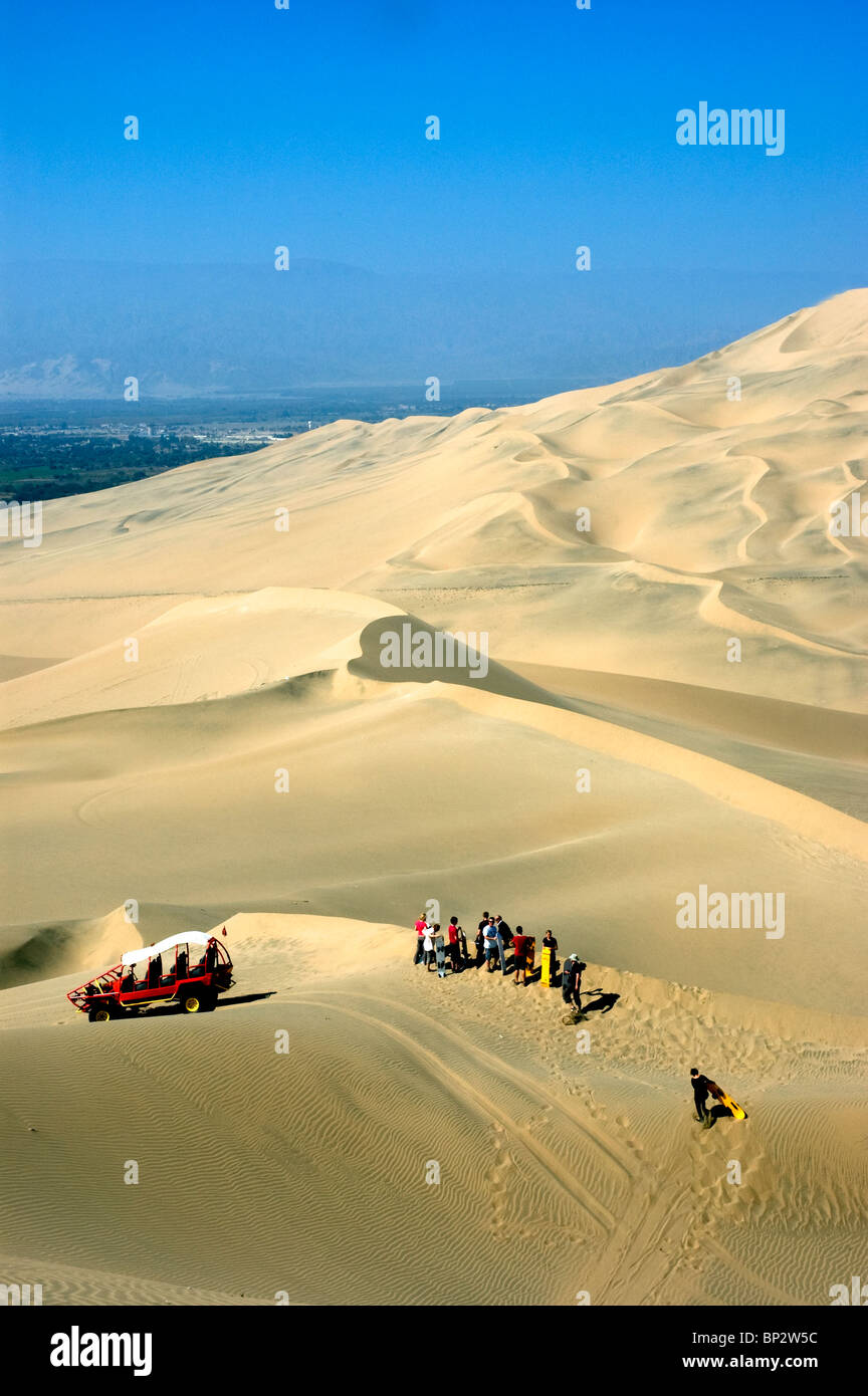 Dune buggies with tourists sand boarding on the vast desert sand dunes near the Huacachina Oasis, Ica, Peru. Stock Photo