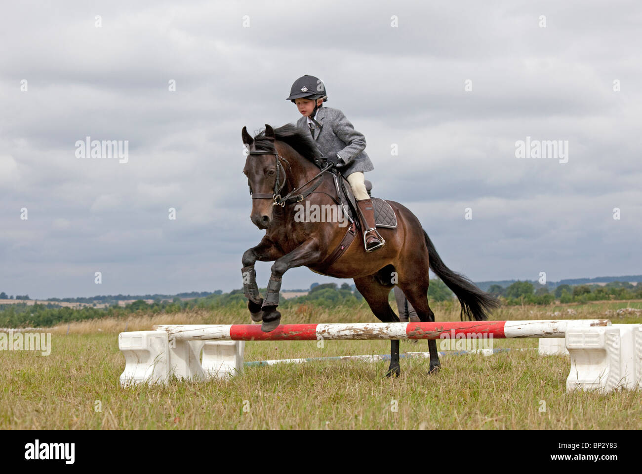 Young girl horse jumping competition gymkhana pony club camp North Cotswolds UK Stock Photo