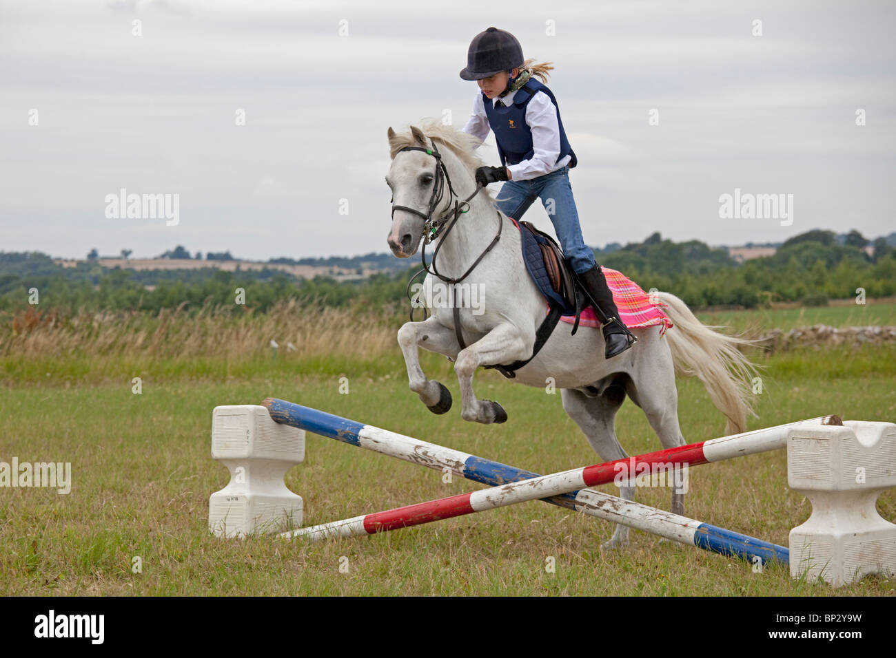 Young girl white horse jumping competition gymkhana pony club camp