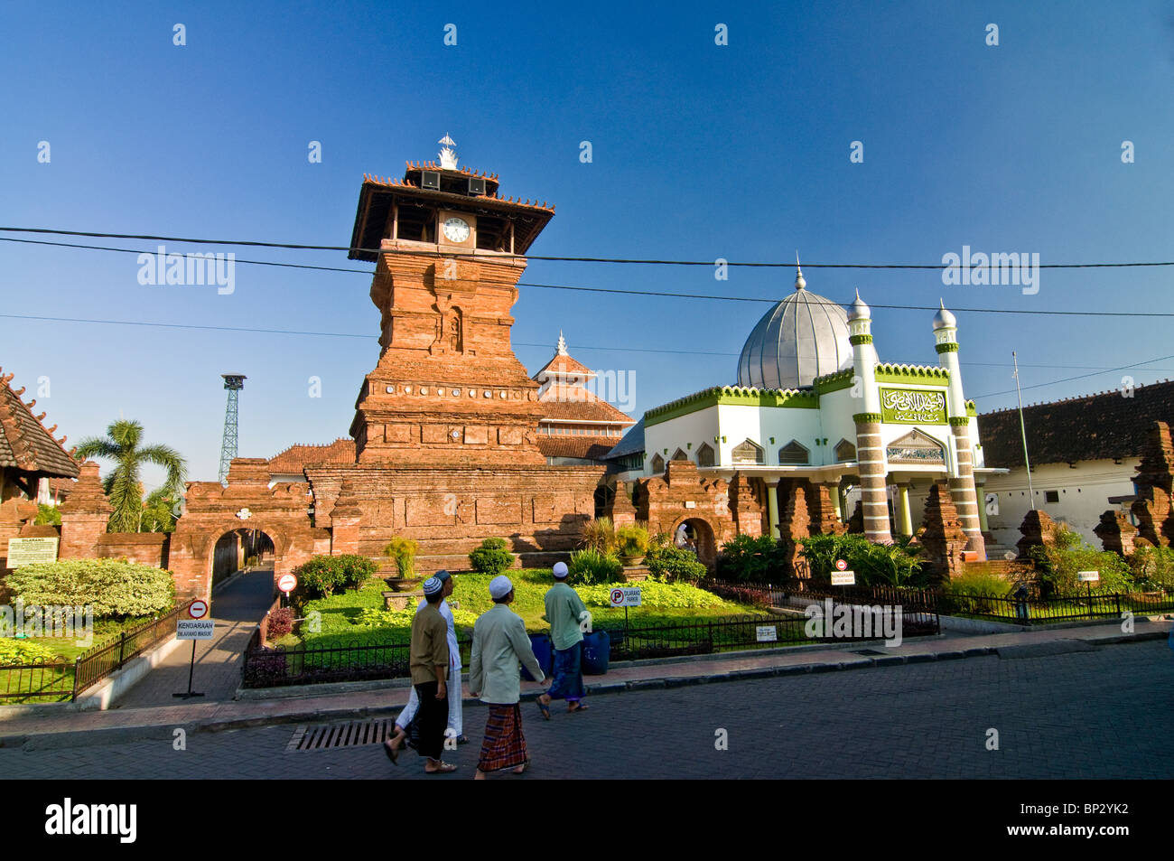 People walking goes to Menara Masjid Kudus for praying Stock Photo