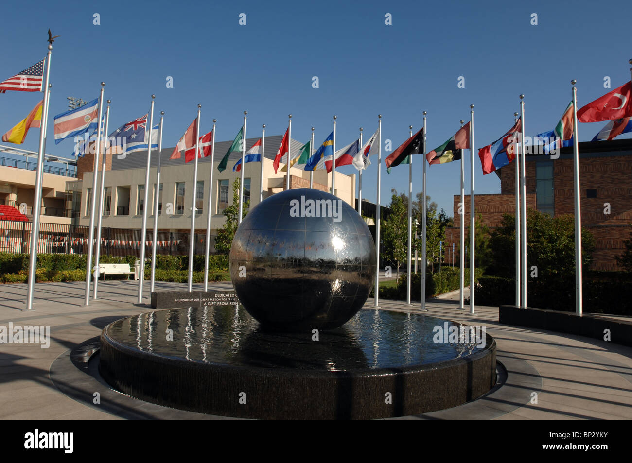 Chapman University's  Global Citizen's Plaza Fountain with flags of many nations and a globe which rotates within a granite pool Stock Photo