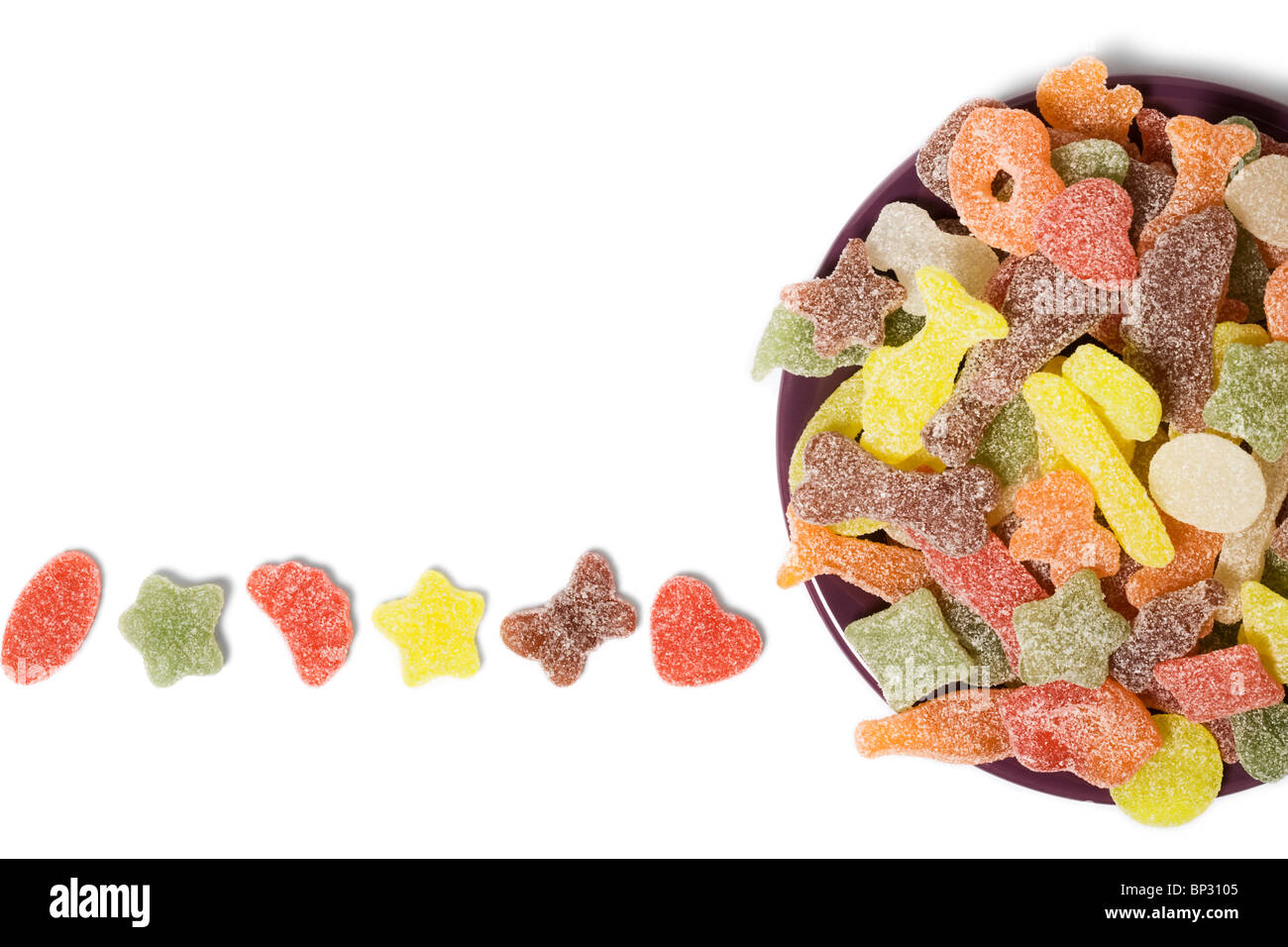 Bowl of assorted multi Colored sour sweets on white background Stock Photo