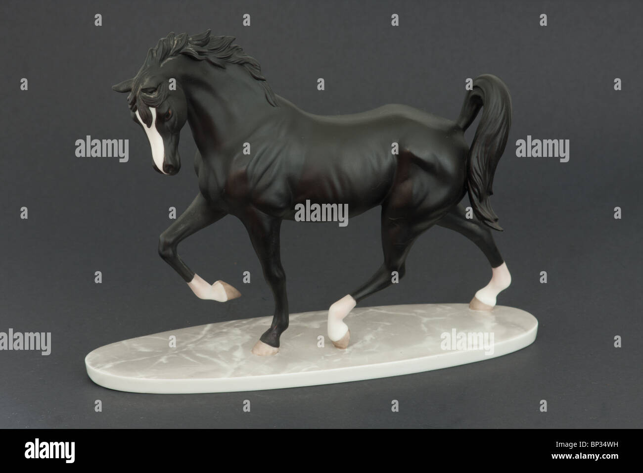 porcelain horse figurine statue on white marble base, Black Stallion Stock Photo